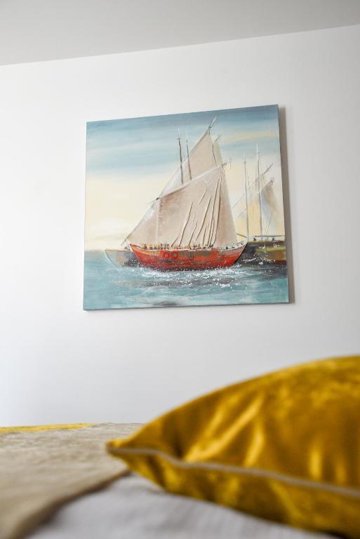 a painting of a sail boat in the water at Hotel Meduza in Senj