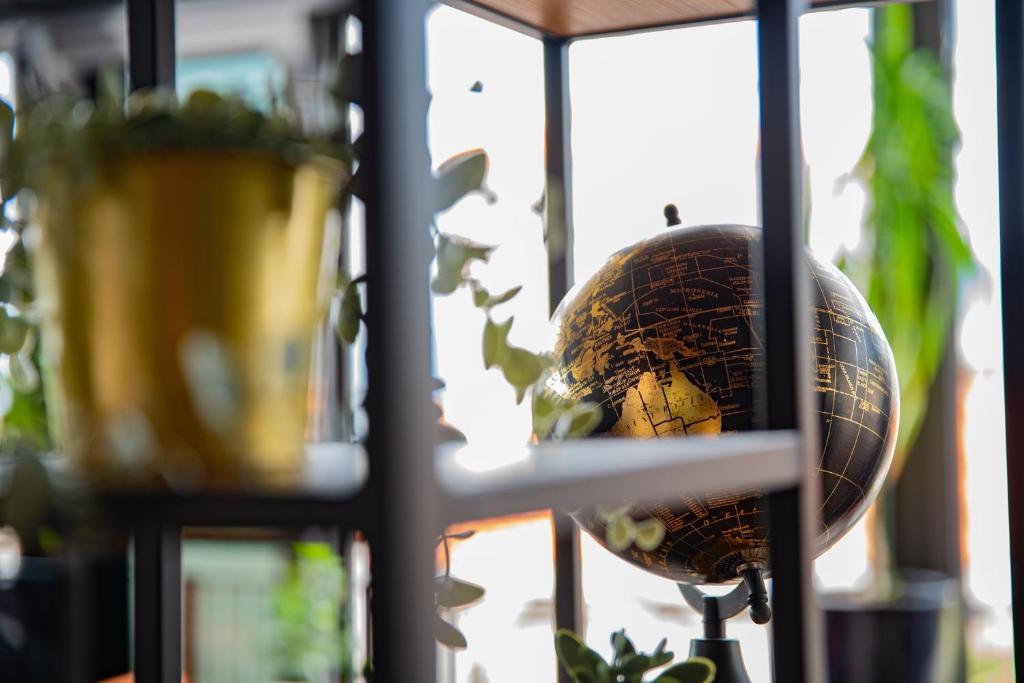 a globe in a window next to a plant at Hotel Meduza in Senj