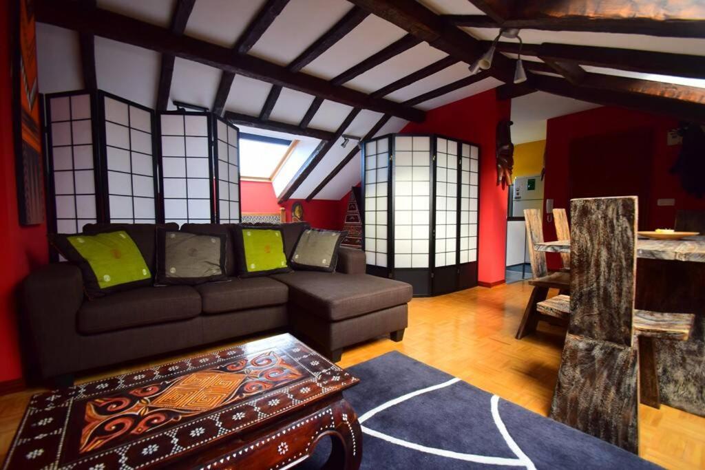 a living room with a couch and a table at Apartamento Loft in Navia