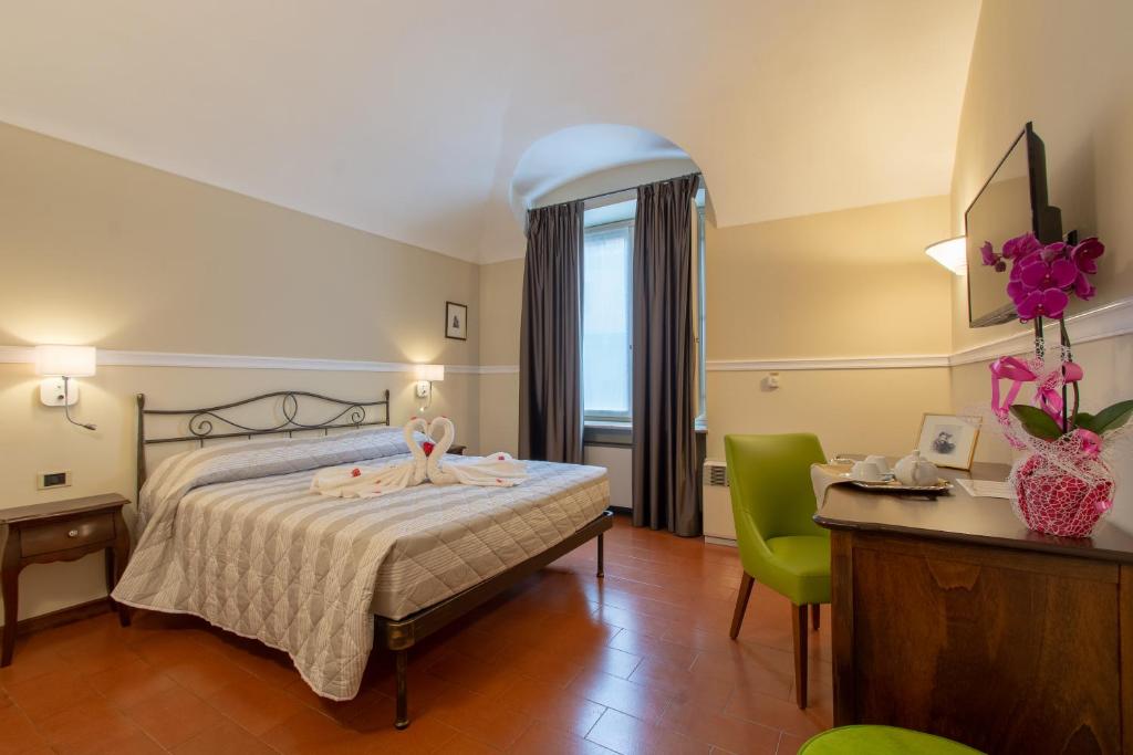 Postel nebo postele na pokoji v ubytování Hotel Antica Dogana