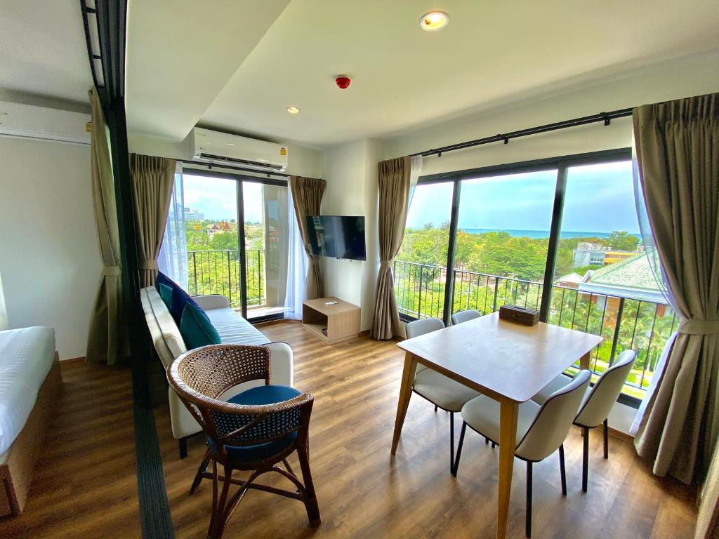a living room with a bed and a table and chairs at La Habana Hua Hin 2 Bedroom Seaview in Hua Hin