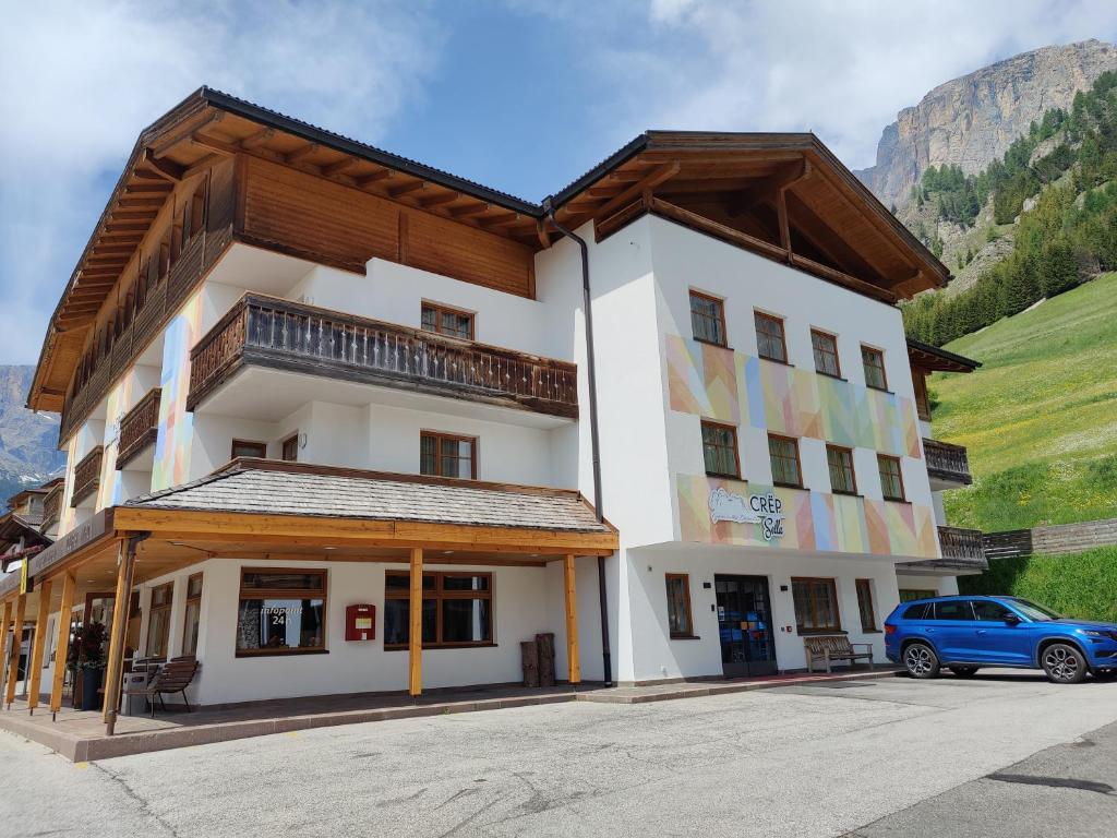 a building with a car parked in front of it at Crëp Sella in Colfosco