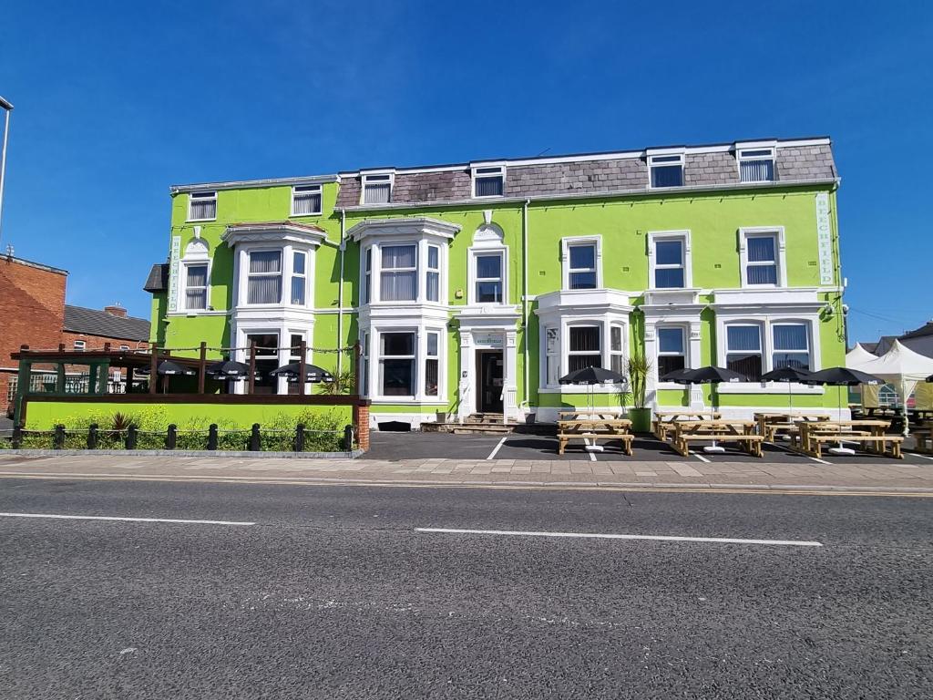 a green and white building on the side of a street at The Beechfield Hotel in Blackpool