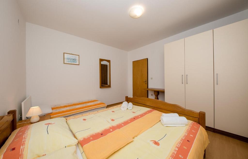 Postel nebo postele na pokoji v ubytování Apartments Halovic