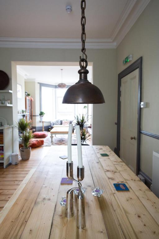 a dining room with a table with three candles on it at CloudZen in Kent