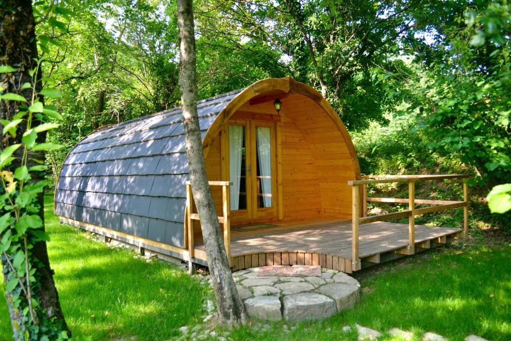 a wooden cabin with a glass dome in the woods at Glamping Dragonja River in Šmarje