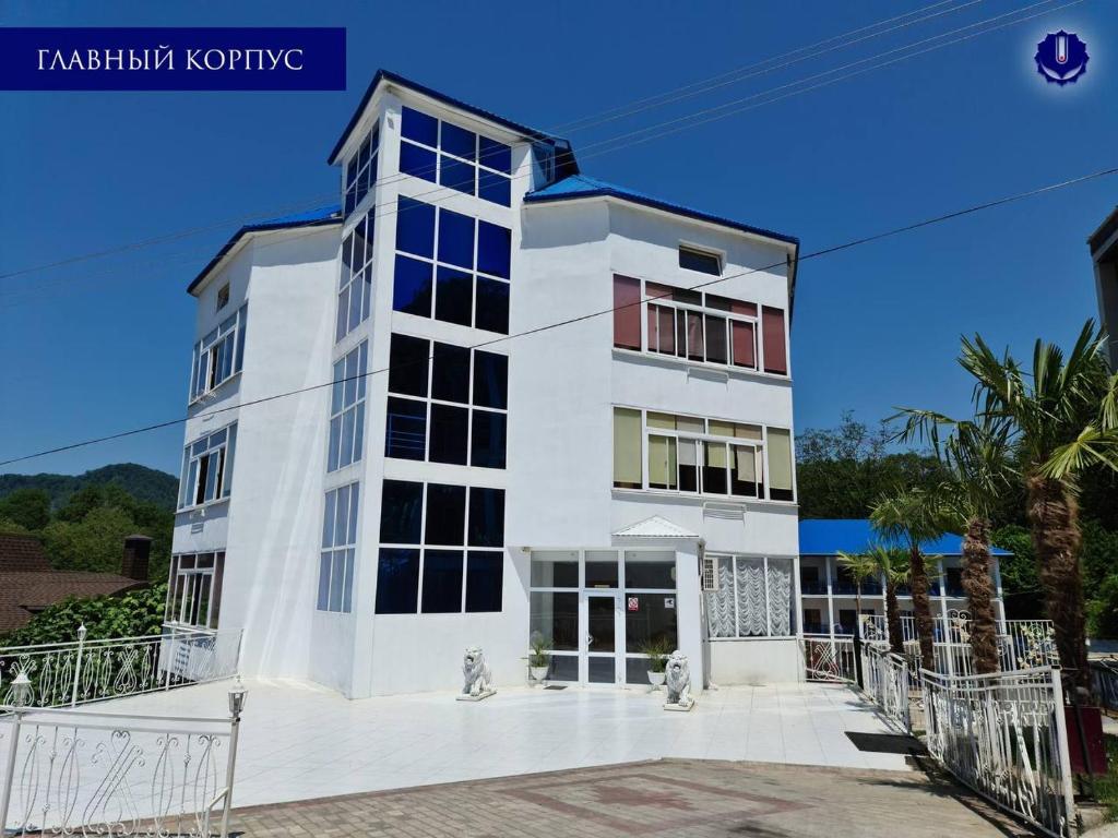 a white building with a lot of windows at Narayana in Loo