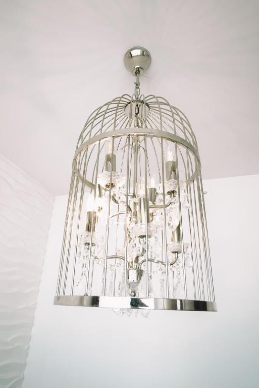 a bird cage hanging from a ceiling at Hotel AVA in Sempach Station