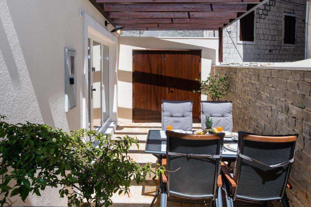 a patio with two chairs and a table on a patio at House Andro in Primošten