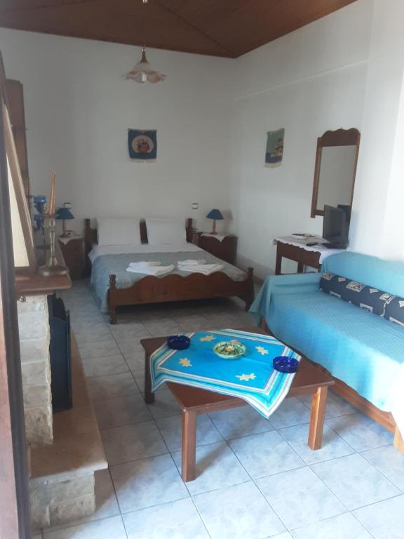 a room with two beds and a table in it at Studio next to the main Square in Zagora