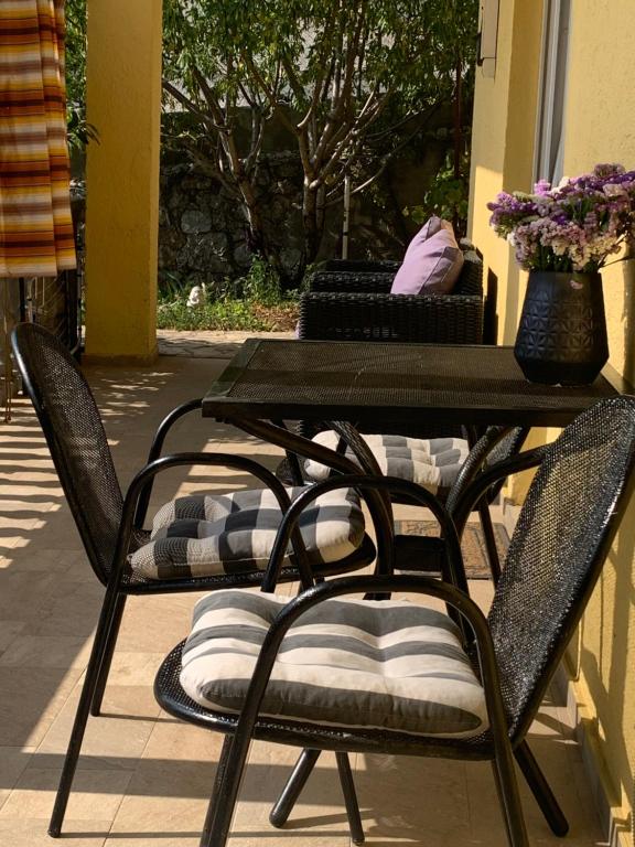 a patio table with two chairs with pillows on it at Apartment Marino in Senj