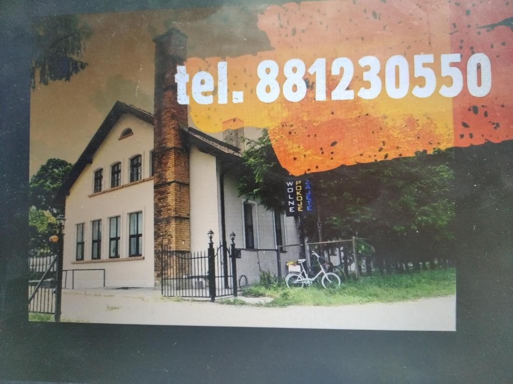 a picture of a house with a clock on it at Pokoje przy trasie S-7 Zajezierze 8 14-330 in Małdyty