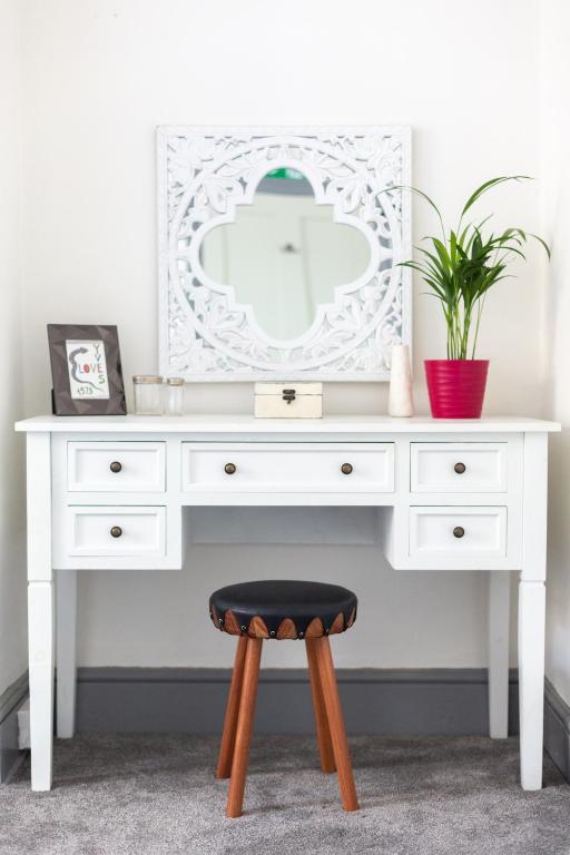 a white desk with a stool and a mirror at CloudZen in Kent