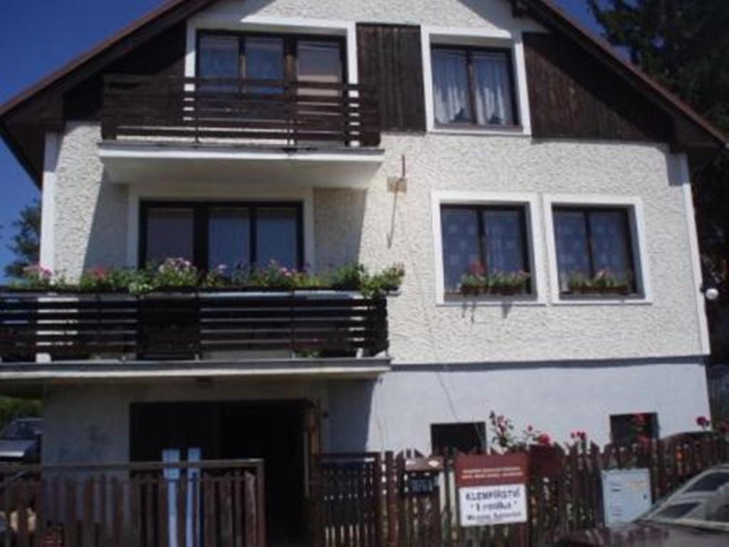 a white house with balconies and plants on it at Penzion a apartmán Renata in Třeboň