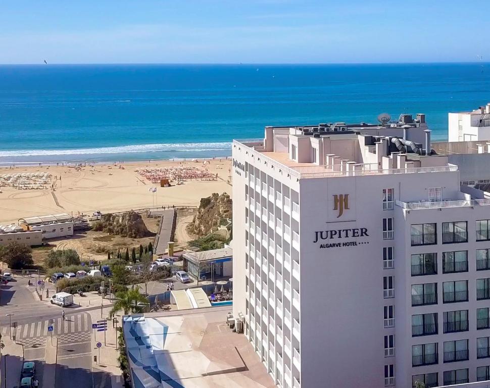 a view of a hotel and the beach at Jupiter Algarve Hotel in Portimão