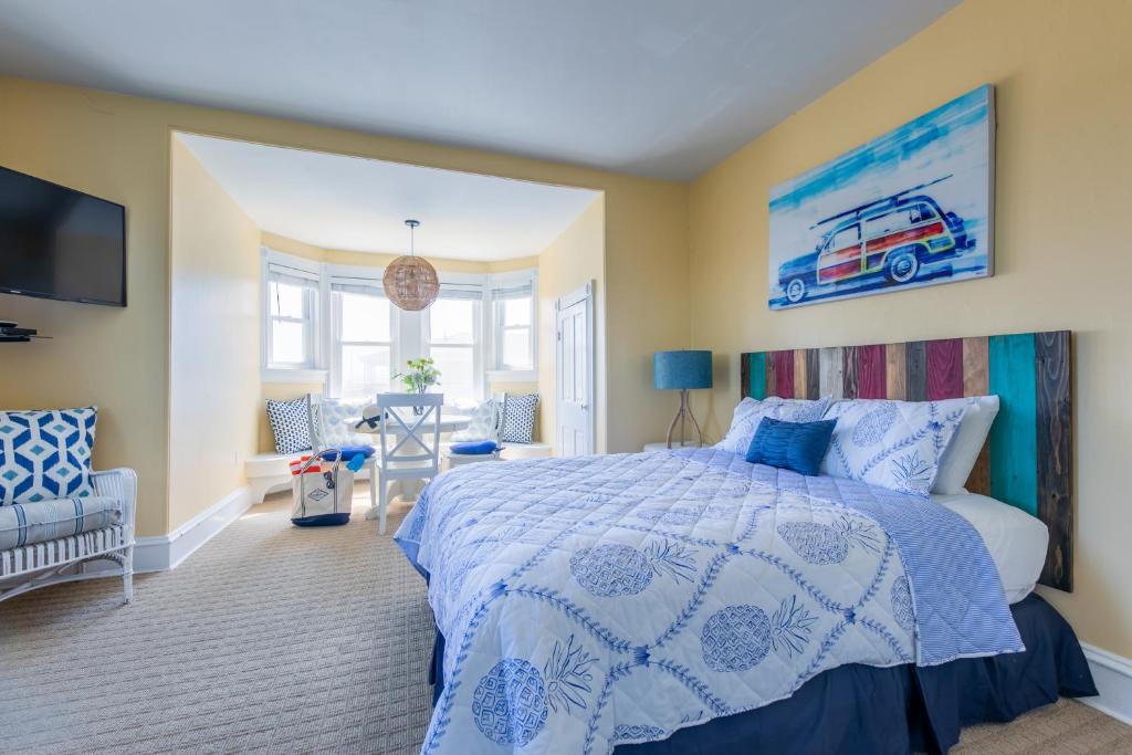 a bedroom with a bed with a blue and white bedspread at Windward at the Beach in Beach Haven