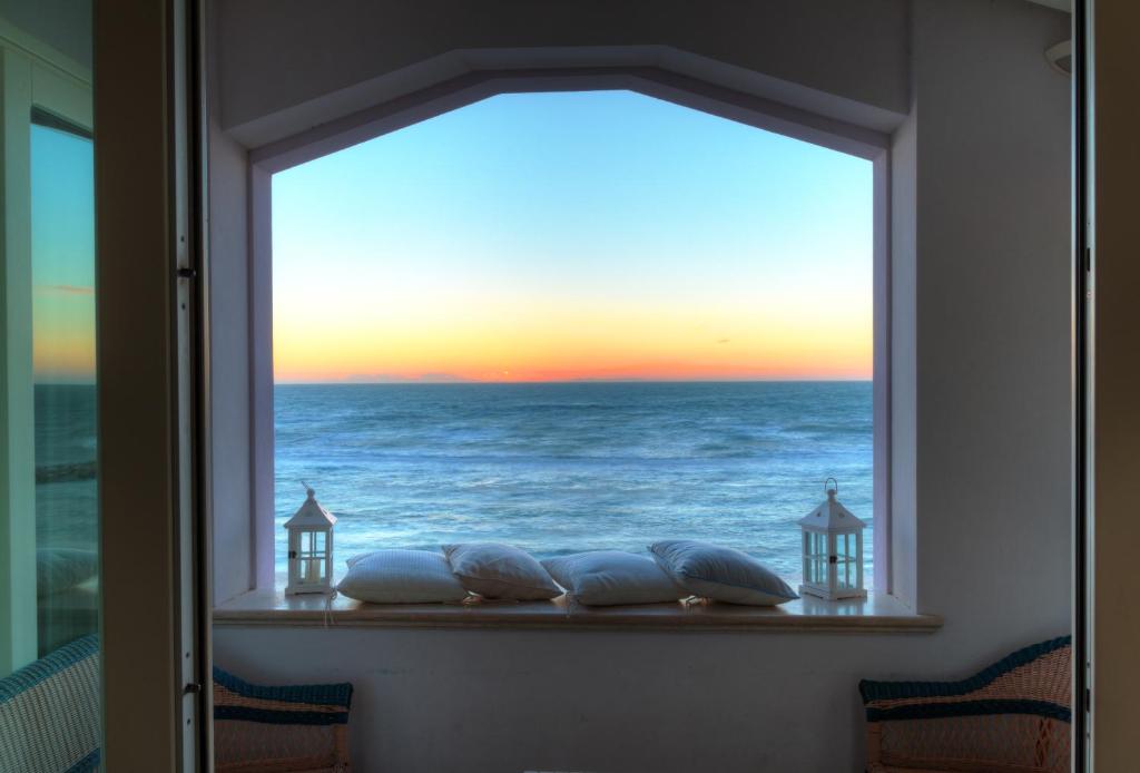 a window with a view of the ocean at Villa Lilla sulla Spiaggia di San Vincenzo LUXURY in San Vincenzo