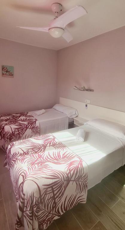 Postel nebo postele na pokoji v ubytování Hostal La Cabaña