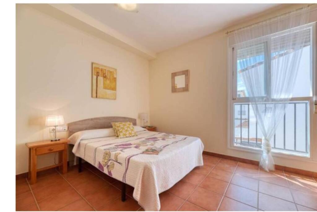 a bedroom with a bed and a window at ENCANTADORA CASA CON PISCINA A 5 MIN PLAYA WIFI in Alcossebre