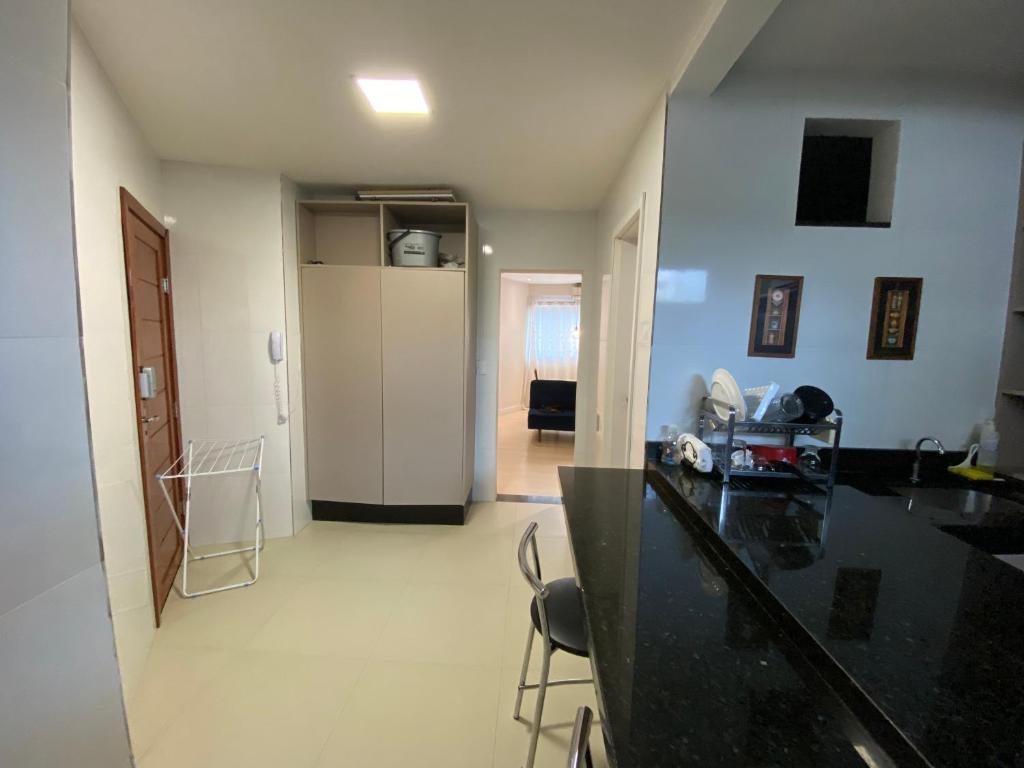 a kitchen with a black counter top in a room at Moradas Pará in Belém