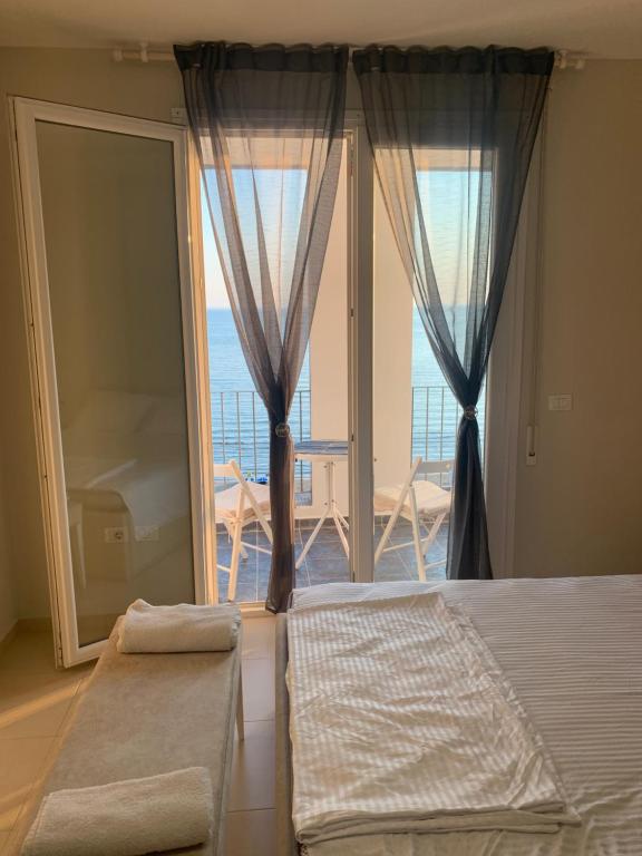 a bedroom with a bed and a view of the ocean at viki sea view apartment in Durrës