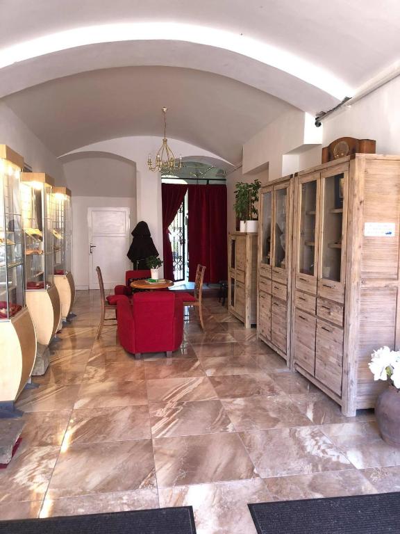 a living room with a red couch and a table at Apartmány u sv. Michaela in Kadaň