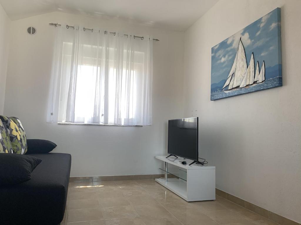 TV a/nebo společenská místnost v ubytování Apartmani Paula