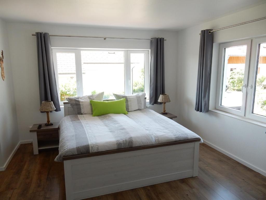 a bedroom with a bed with a window at Fünf Harzer Berge Ferien Apartments in Sankt Andreasberg