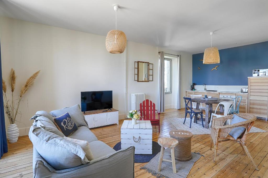 a living room with a couch and a table at Résidence L'Aristide : Appartement Malo in Auray