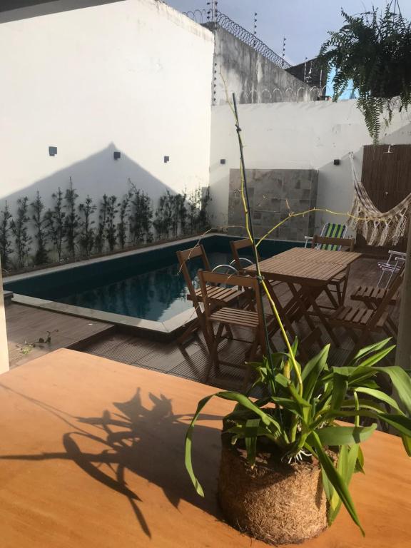a patio with a table and a swimming pool at Casa Pérola do Caeté in Bragança