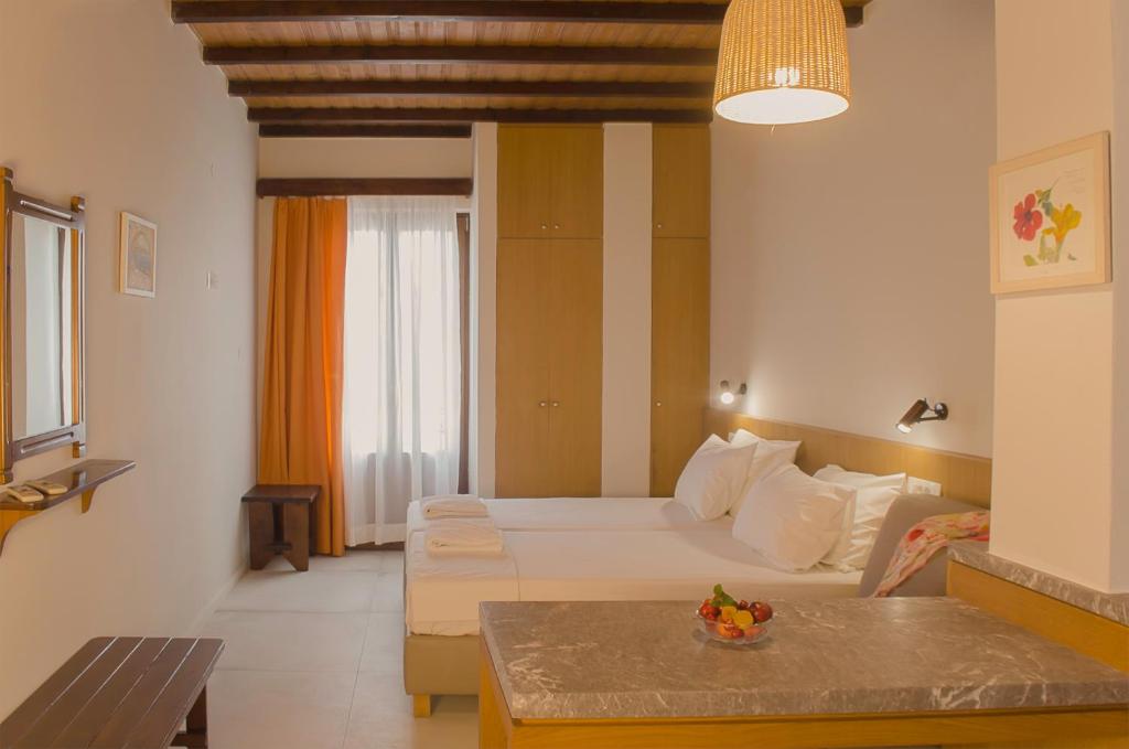 A bed or beds in a room at Kalypso Studios & Rooms