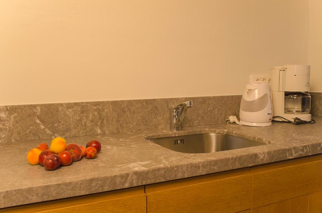 A kitchen or kitchenette at Kalypso Studios & Rooms