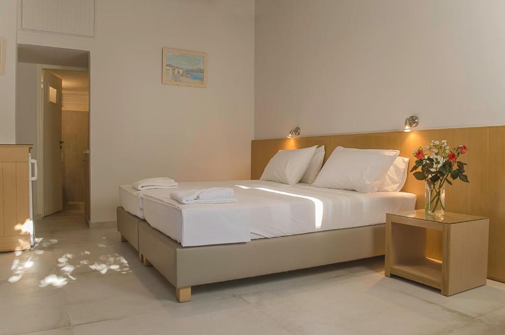 A bed or beds in a room at Kalypso Studios & Rooms