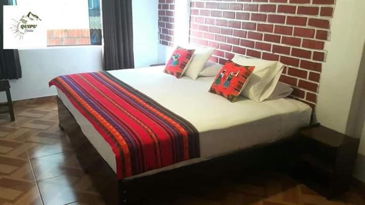 Postel nebo postele na pokoji v ubytování Quipu Hostal