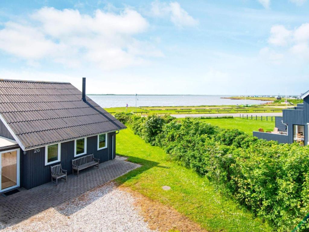 a small house with a view of the ocean at 8 person holiday home in Hemmet in Falen