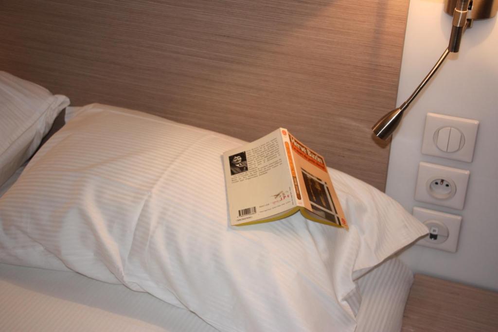Postel nebo postele na pokoji v ubytování Hôtel Terranostra