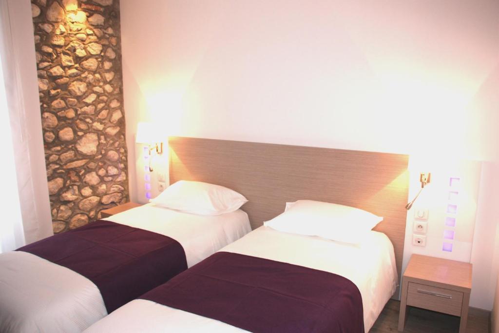 Postel nebo postele na pokoji v ubytování Hôtel Terranostra
