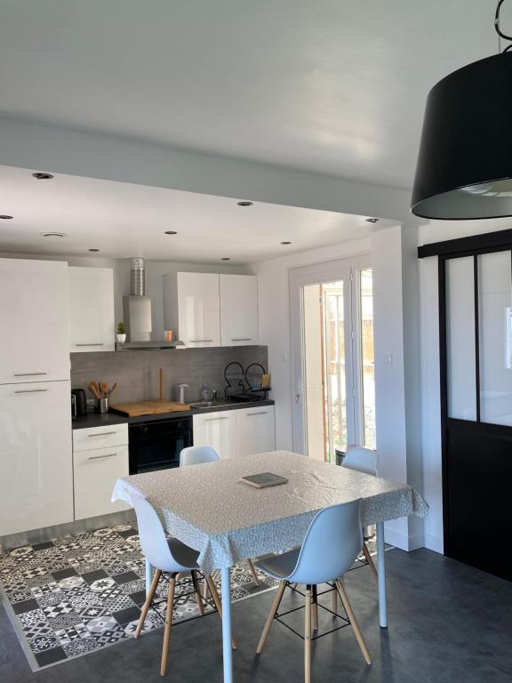 a kitchen with a table and chairs in a room at Gîte « la sakalava » vue panoramique faron in Toulon