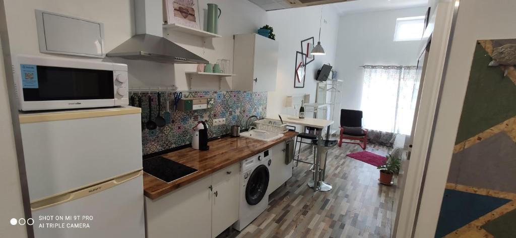 a kitchen with a washer and dryer in a room at Huelintown in Málaga