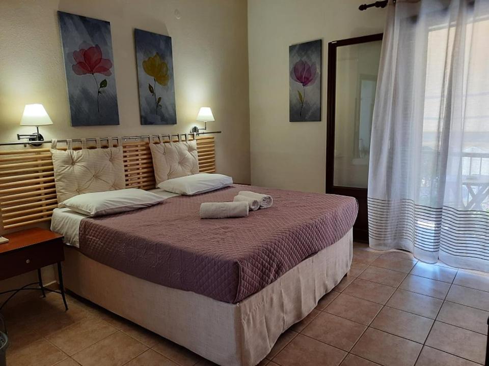 Postel nebo postele na pokoji v ubytování ΑΡΓΩ