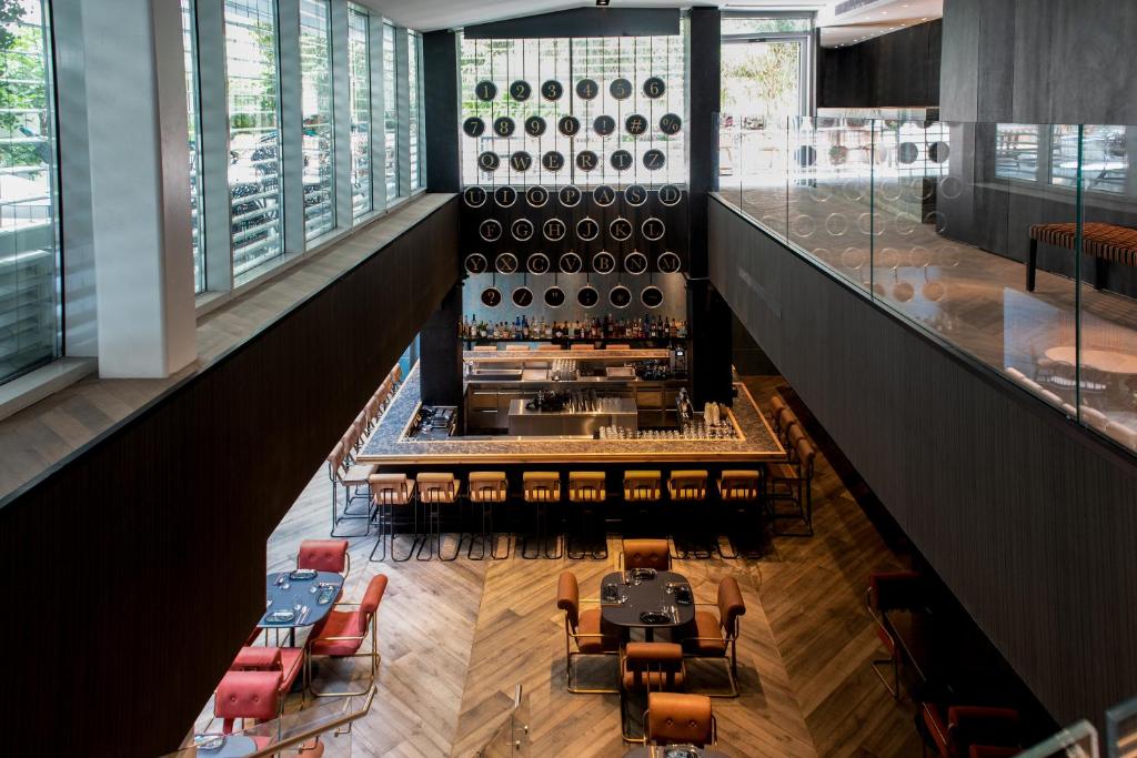 an overhead view of a wine cellar with tables and chairs at Ink Hotel in Tel Aviv