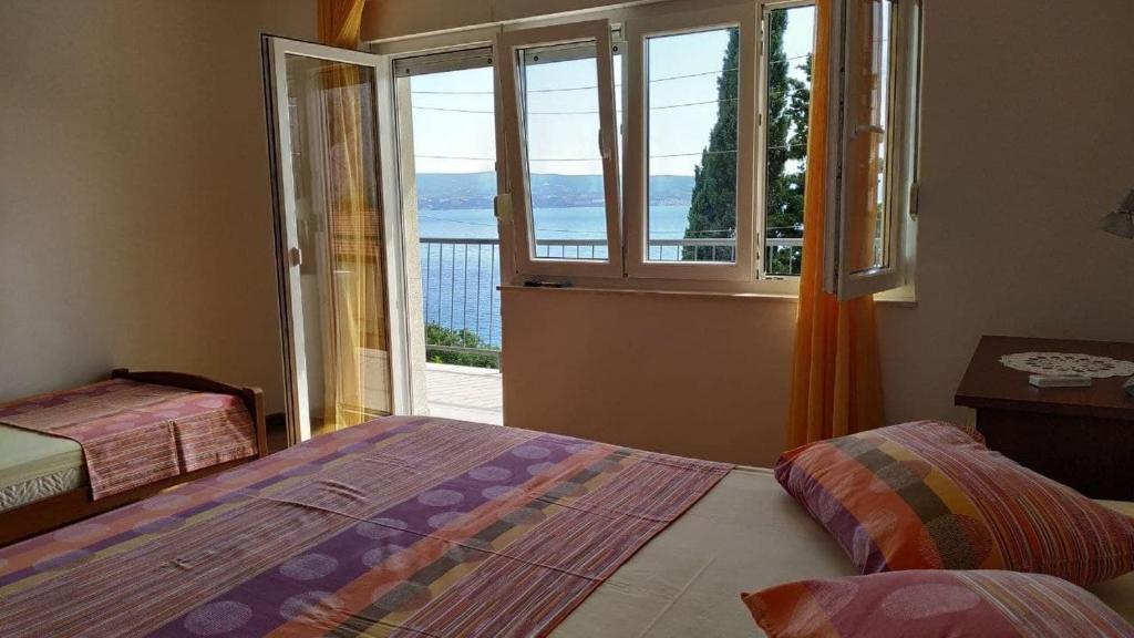 a bedroom with a bed and a window with a view at Apartment Kate in Omiš