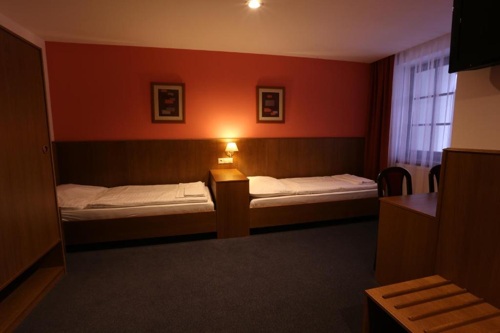 Postel nebo postele na pokoji v ubytování Hotel Hajčman