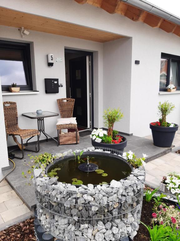 a small pond in the middle of a patio at Zettler`s Ferienwohnung in Aichstetten