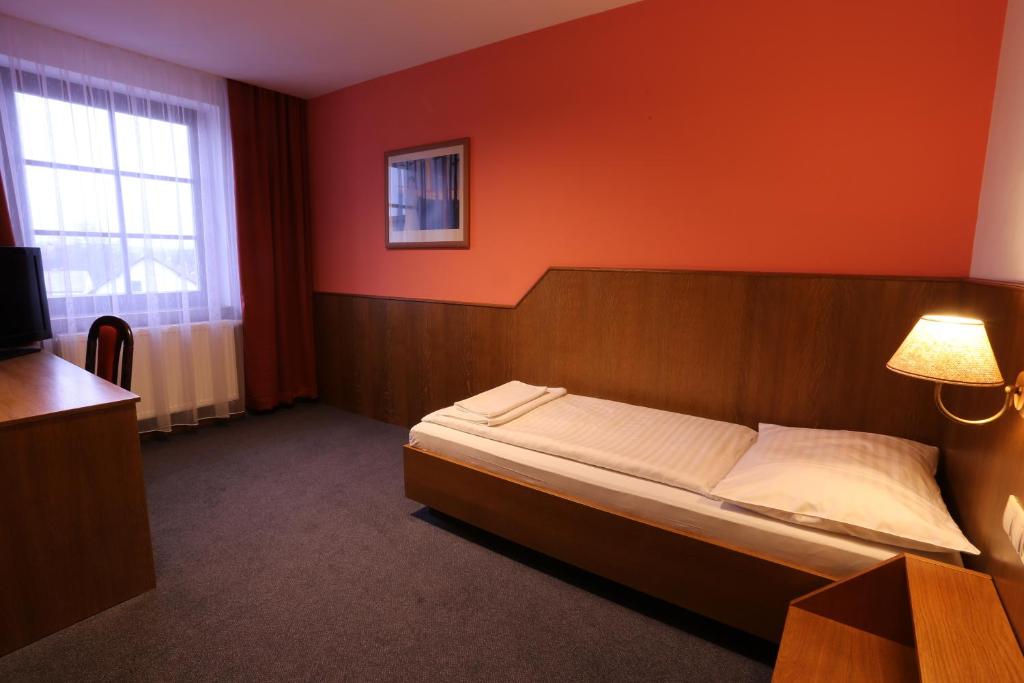 Postel nebo postele na pokoji v ubytování Hotel Hajčman