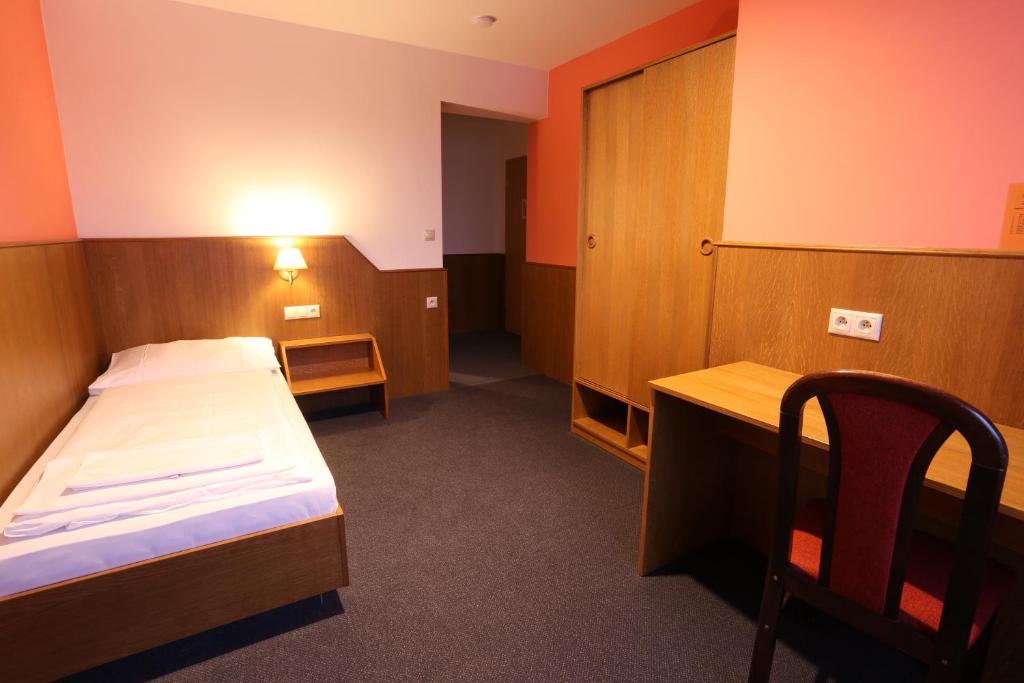 Postel nebo postele na pokoji v ubytování Hotel Hajčman