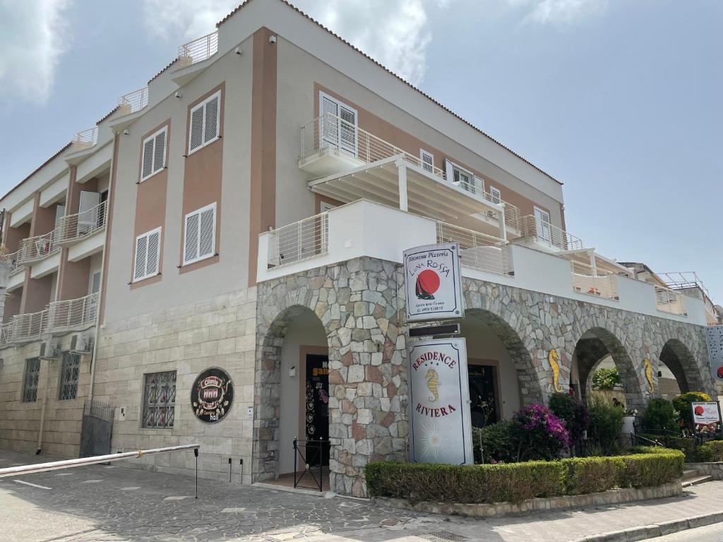 a building with a sign in front of it at Residence Riviera in Palinuro