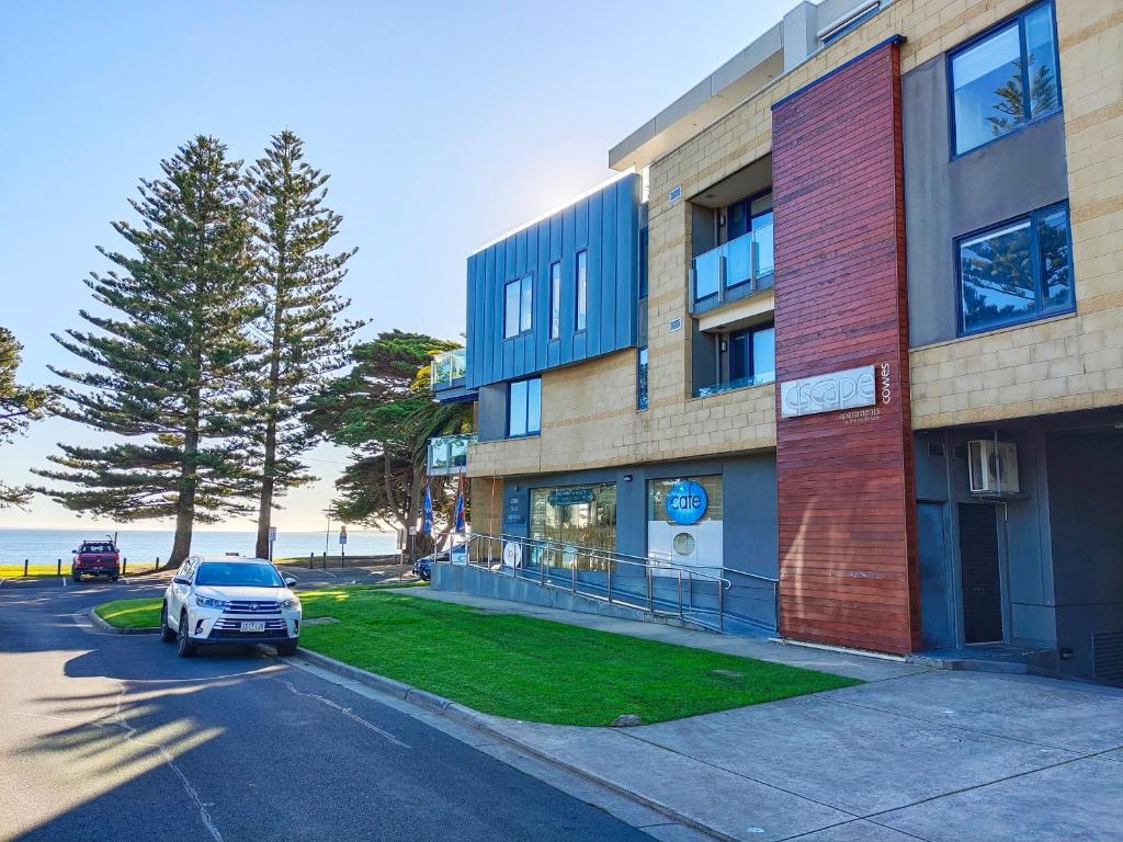 a car parked in a parking lot next to a building at Cscape3 in Cowes