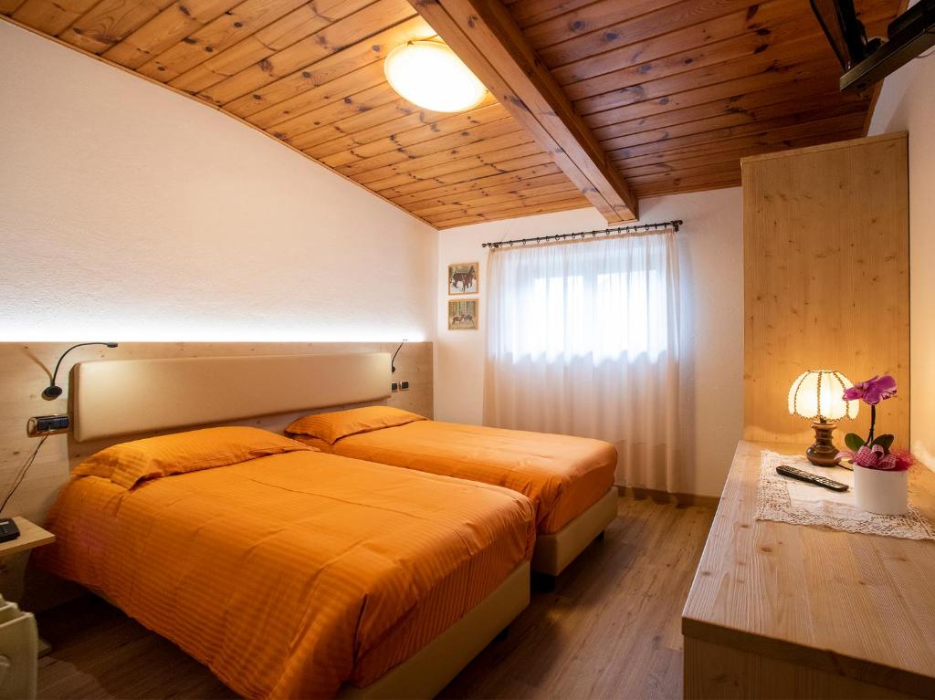 Postel nebo postele na pokoji v ubytování Hotel Adriana