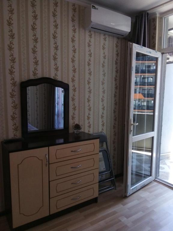 a room with a dresser with a mirror on it at kvartira 120 m do pliaj in Batumi